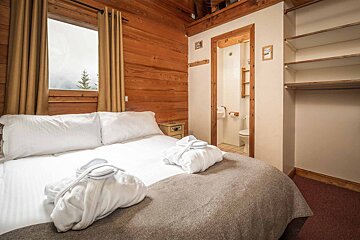 A bedroom with a closet and a toilet
