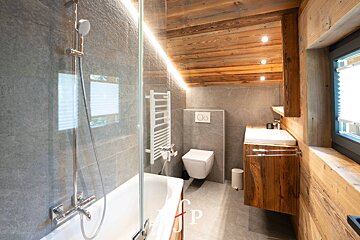 A bathroom with a bathtub a toilet and a sink