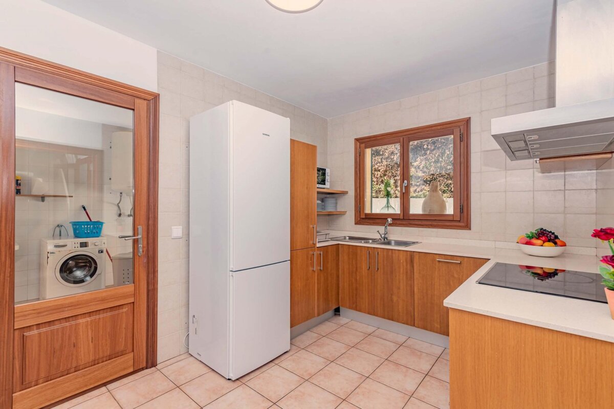 A kitchen with a siemens refrigerator and a washing machine