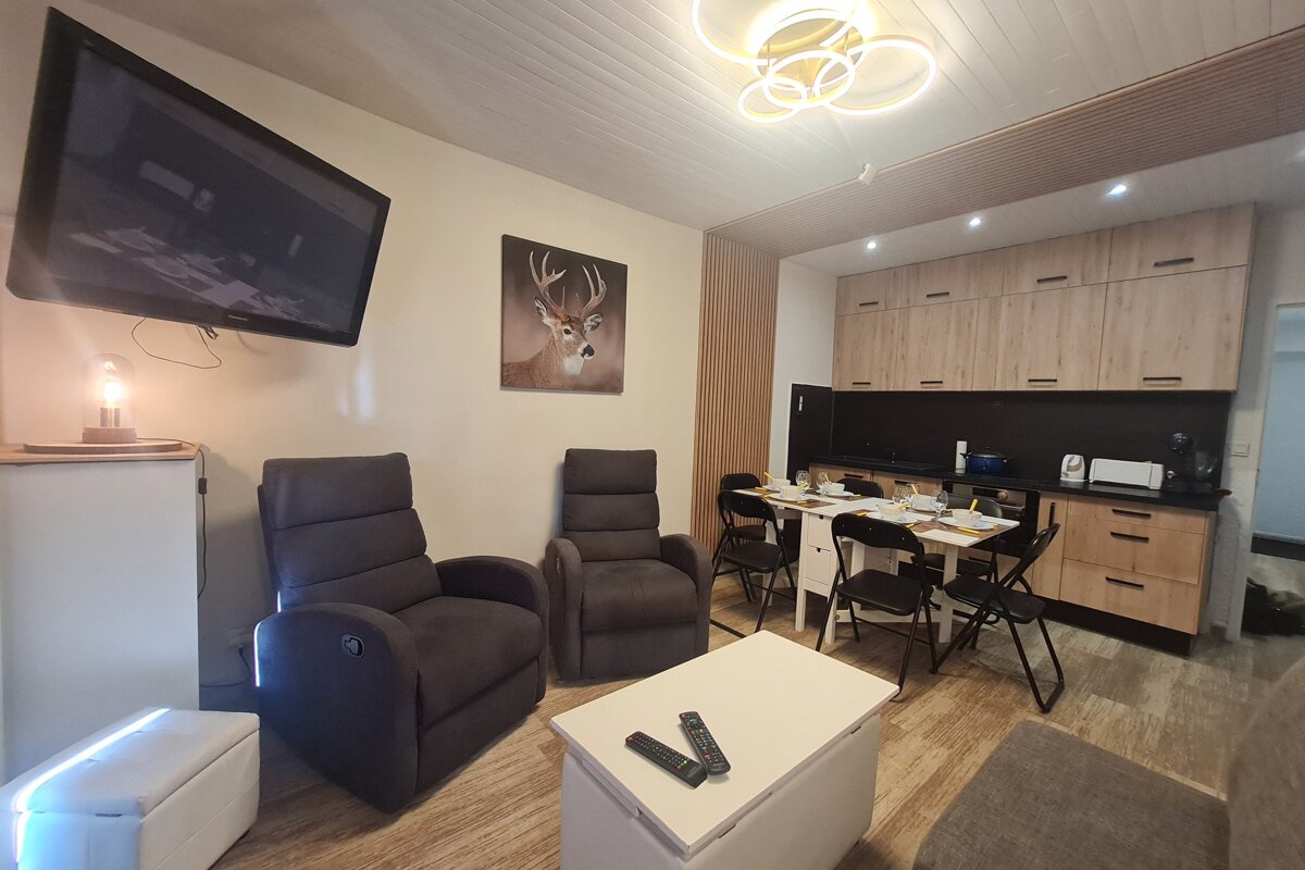 A living room with a painting of a deer on the wall