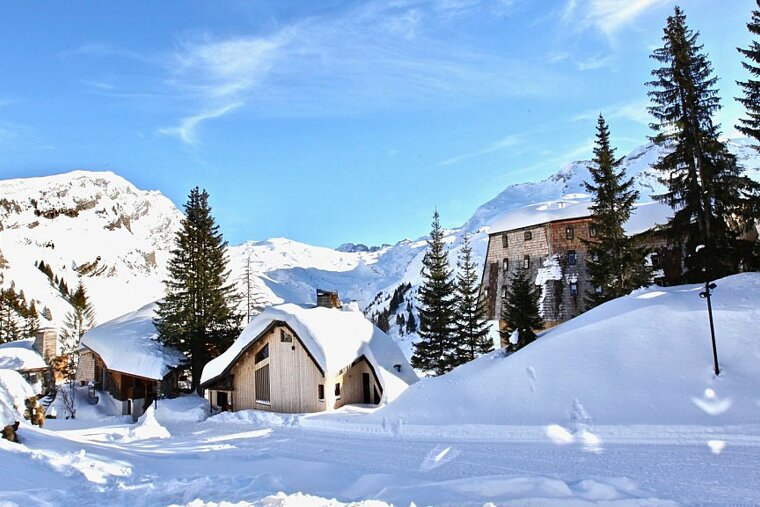 A snowy landscape with a house in the middle