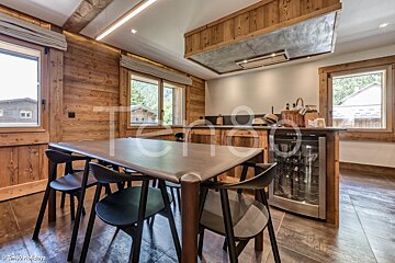 A kitchen with a table and chairs and the word holidays on the bottom