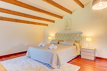 A bedroom with a king size bed and two nightstands