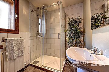 A bathroom with a sink and a shower that says mountain base