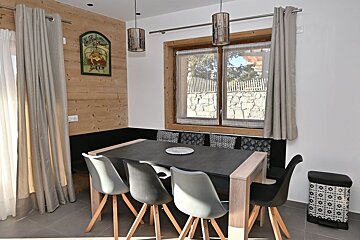 A dining room with a black table and chairs