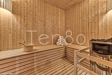 A wooden sauna with the word ten80 on the wall