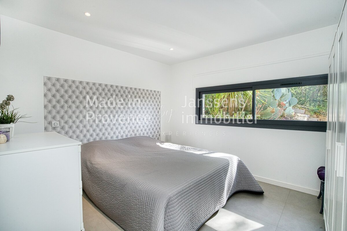 A bedroom with a bed and a window that says made in provence