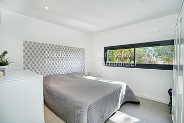 A bedroom with a bed and a window that says made in provence