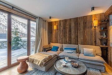 A living room with a couch and a table and a pillow that says eat bugs