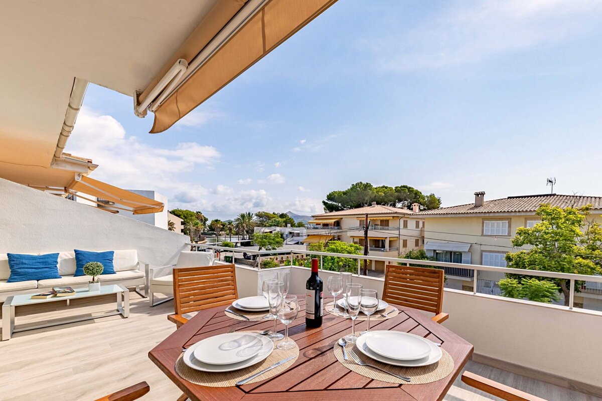 A table with plates and a bottle of wine on it