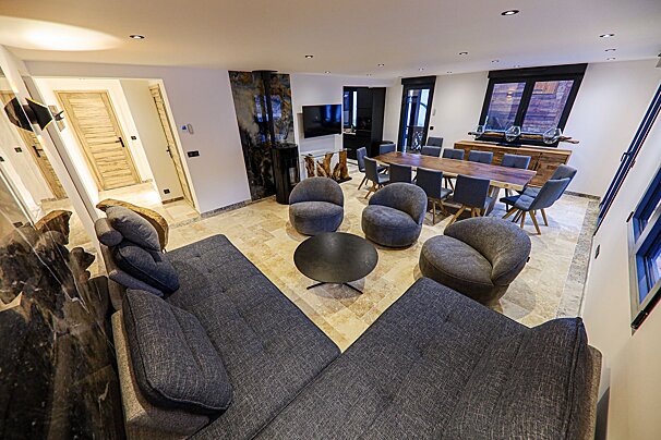 A living room with a couch and chairs and a table