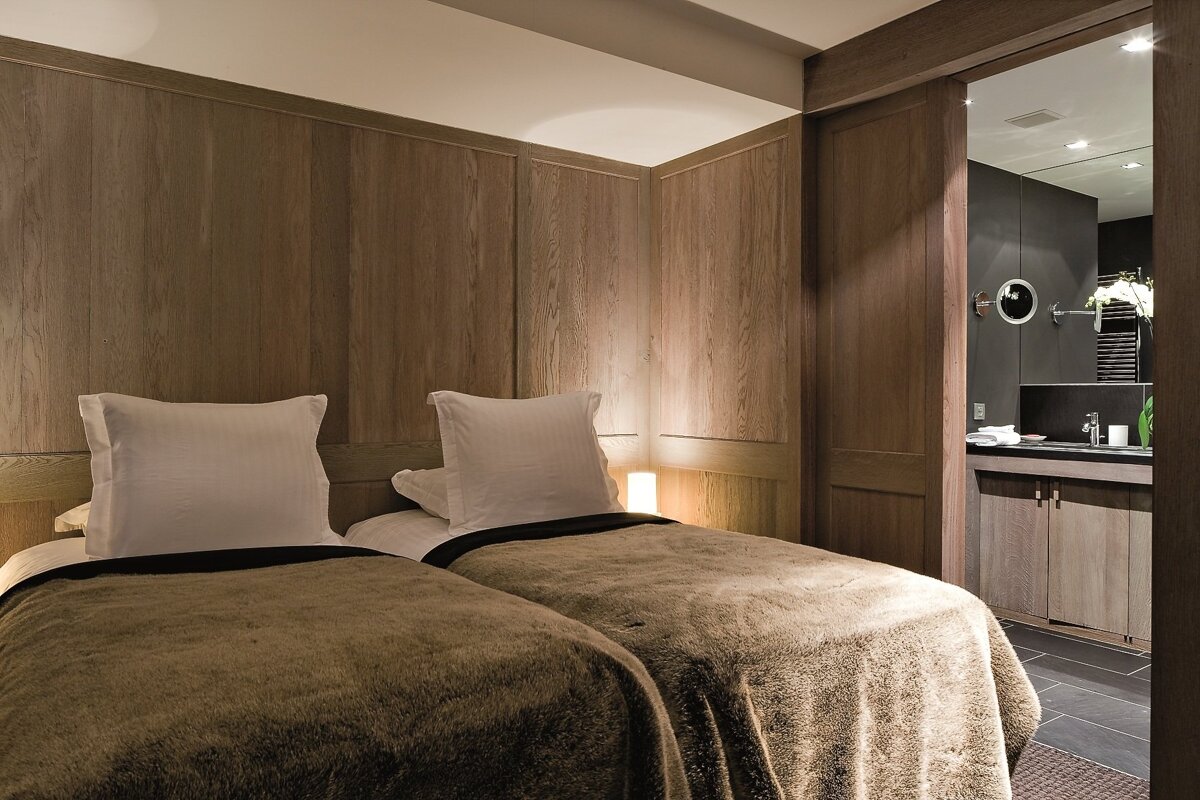 A hotel room with two beds and a bathroom