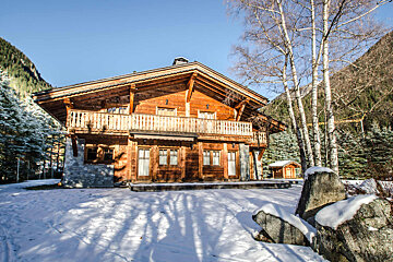 A large wooden house with a large balcony