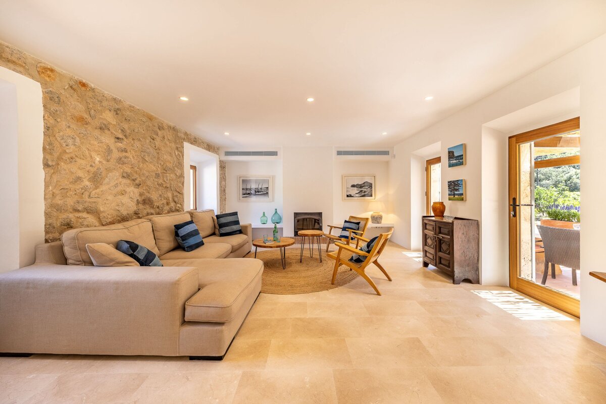 A living room with a couch and chairs and a fireplace