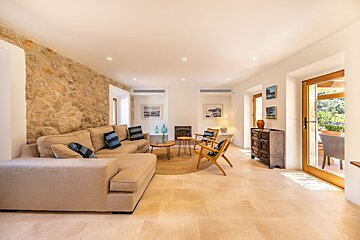 A living room with a couch and chairs and a fireplace
