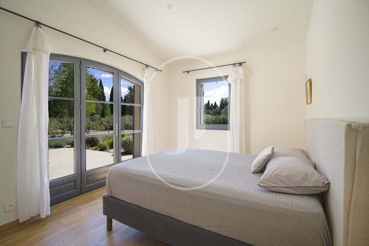 A bedroom with a large bed and a large window