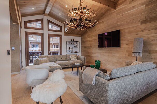 A living room with a couch a chair and a television