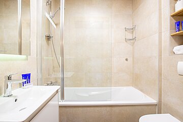 A bathroom with a bathtub a sink and a toilet