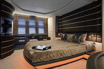 A bedroom with a large bed and a tray on the bed