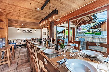 A dining room table with plates and glasses on it