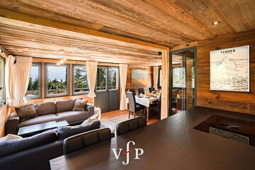 A living room with a poster on the wall that says verbier