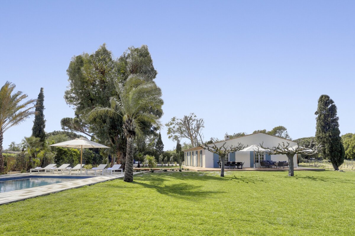 A house with a swimming pool in front of it