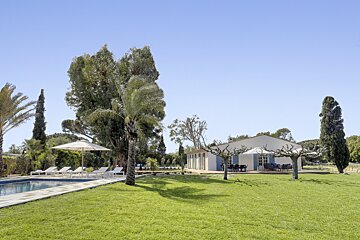 A house with a swimming pool in front of it