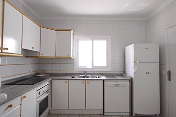 A kitchen with white cabinets and a fridge that says frigidaire