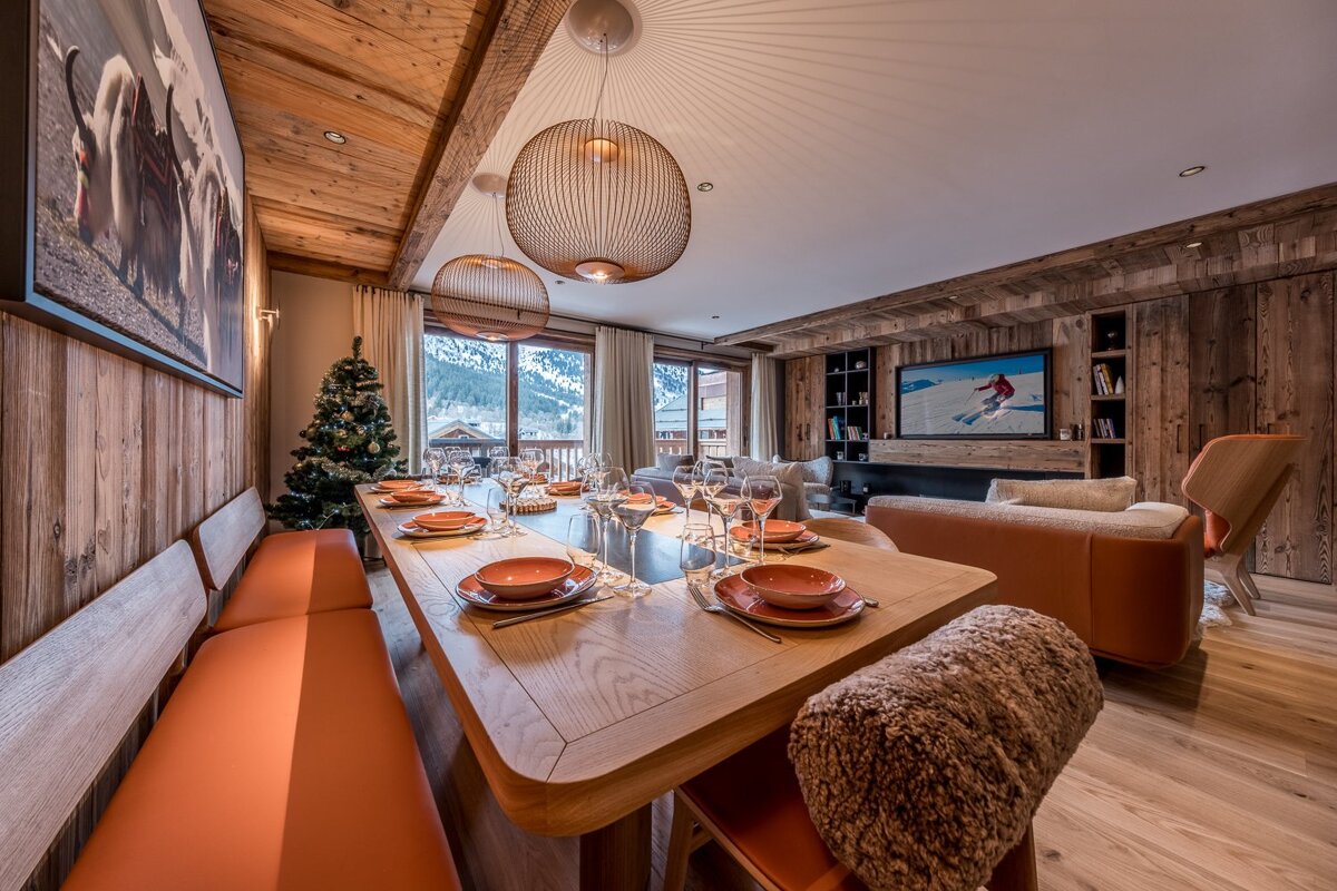 A dining room table with plates and glasses on it