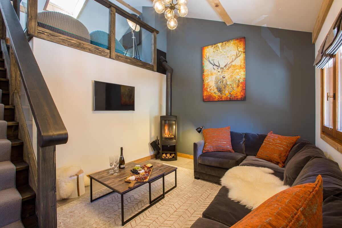 A living room with a couch a table and a television