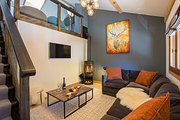 A living room with a couch a table and a television