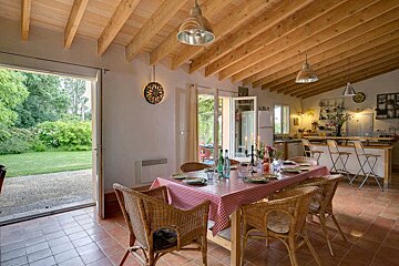 A dining room table with a red and white checkered table cloth