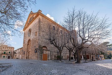 A large stone building with a cross on top of it