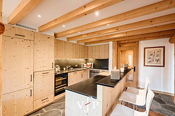 A kitchen with wooden cabinets and a sign that says vjp