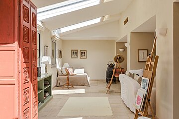 A living room with a couch and an easel