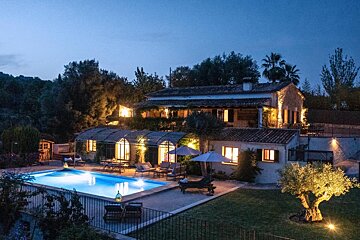 A large house with a swimming pool in front of it