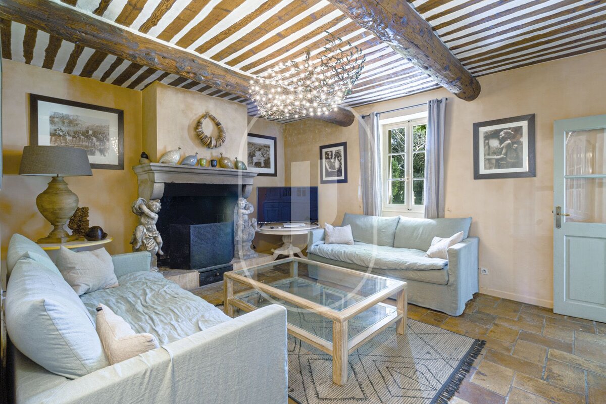 A living room with a fireplace and two couches