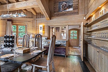 A dining room with a painting of a bear on the wall