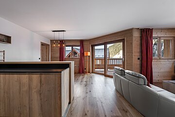 A living room with a couch and a sliding glass door