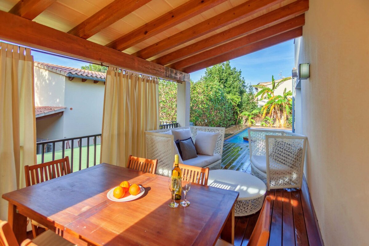 A table with a plate of oranges and a bottle of wine on it