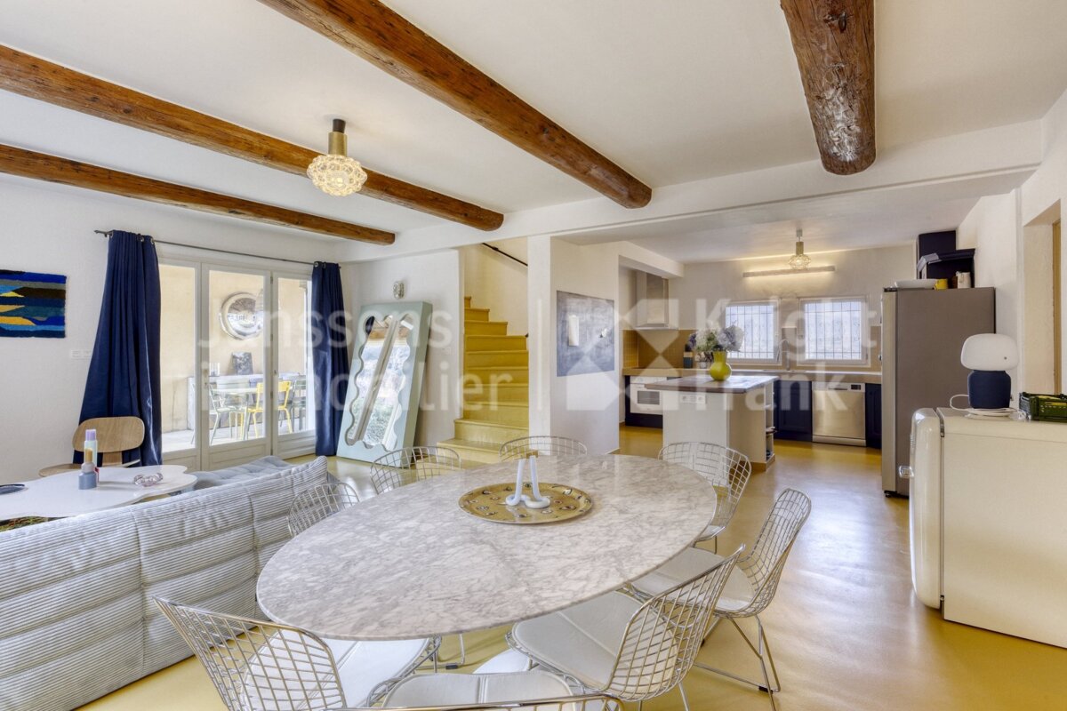 A dining room with a table and chairs and a sign that says frank