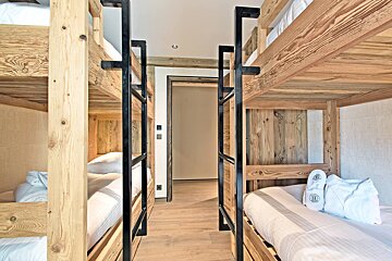 A bunk bed with a pair of slippers on it
