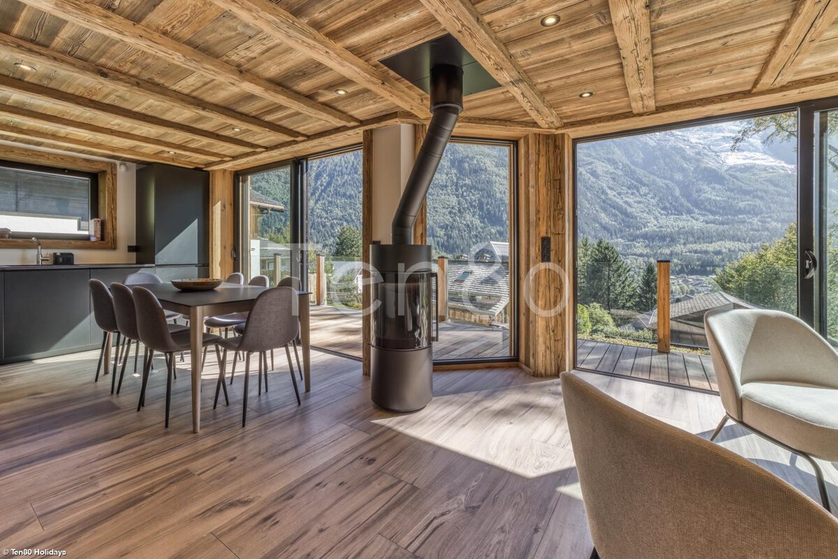 A dining room with a fireplace and a view of the mountains