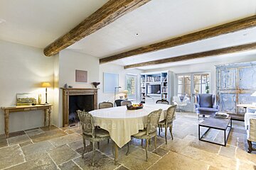 A living room with a table and chairs and a sign that says made in provence