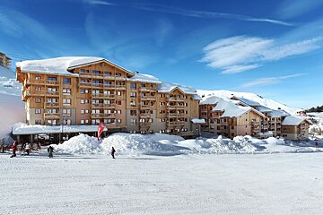 A snowy building with a red flag that says ' a ' on it