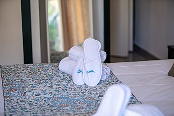 A pair of white slippers with the word sweet on them
