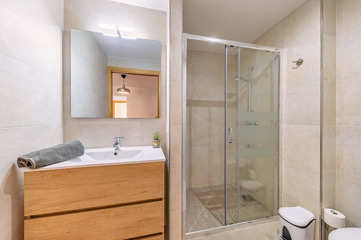 A bathroom with a sink and a walk in shower