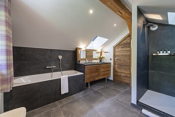 A bathroom with a bathtub and two sinks
