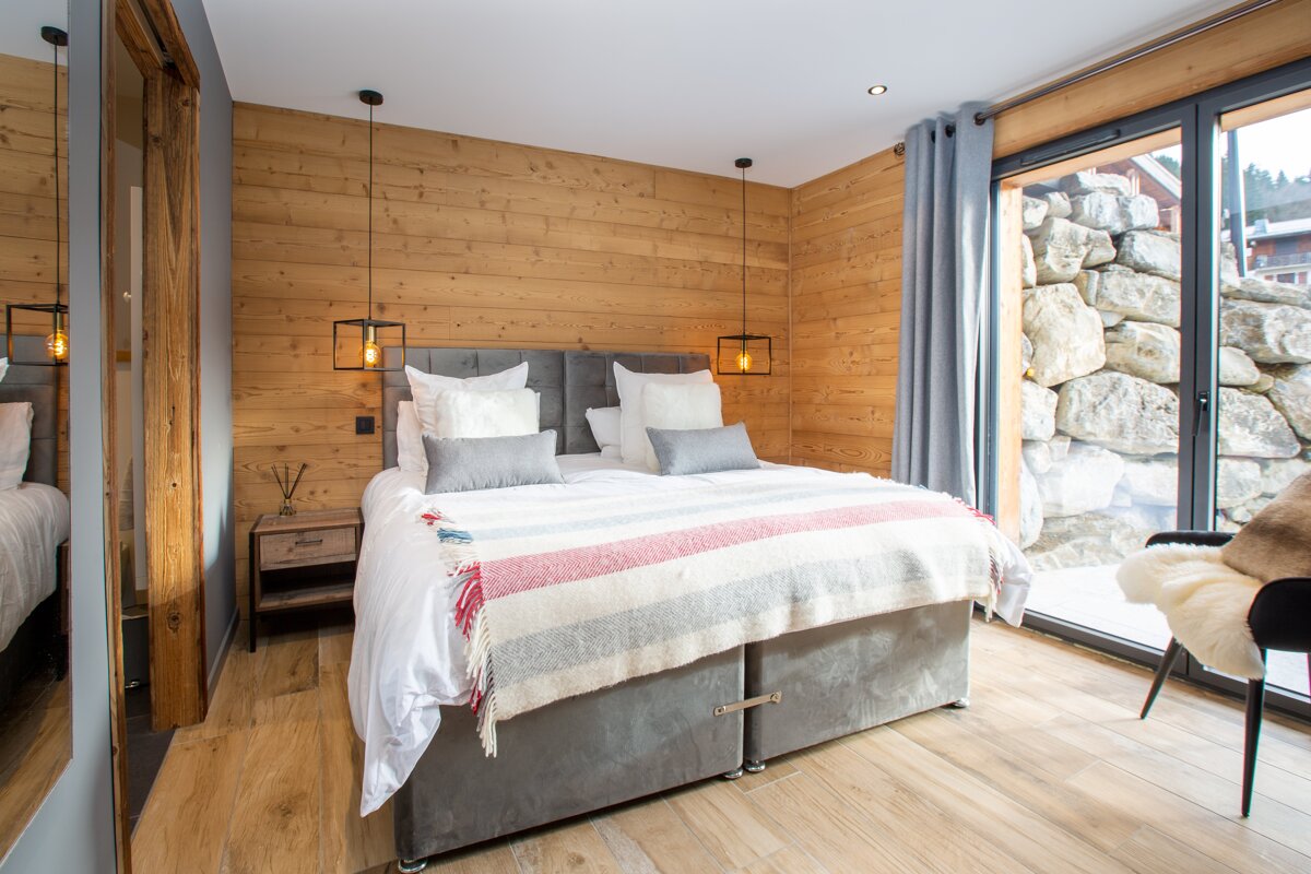 A bedroom with a large bed and a large window