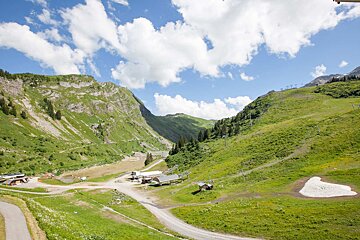A view of a valley with mountains in the background